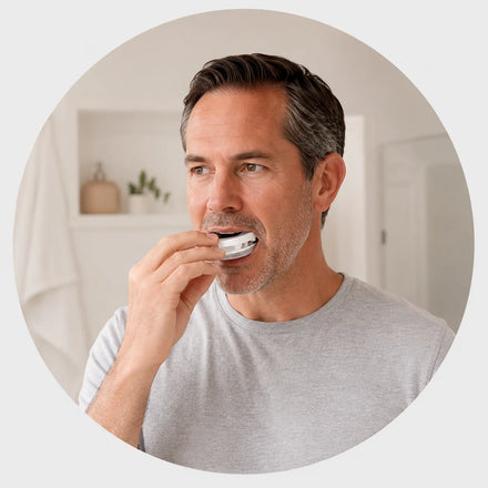 Man placing the Snorbliss anti-snoring mouthpiece in his mouth to mold it to his bite