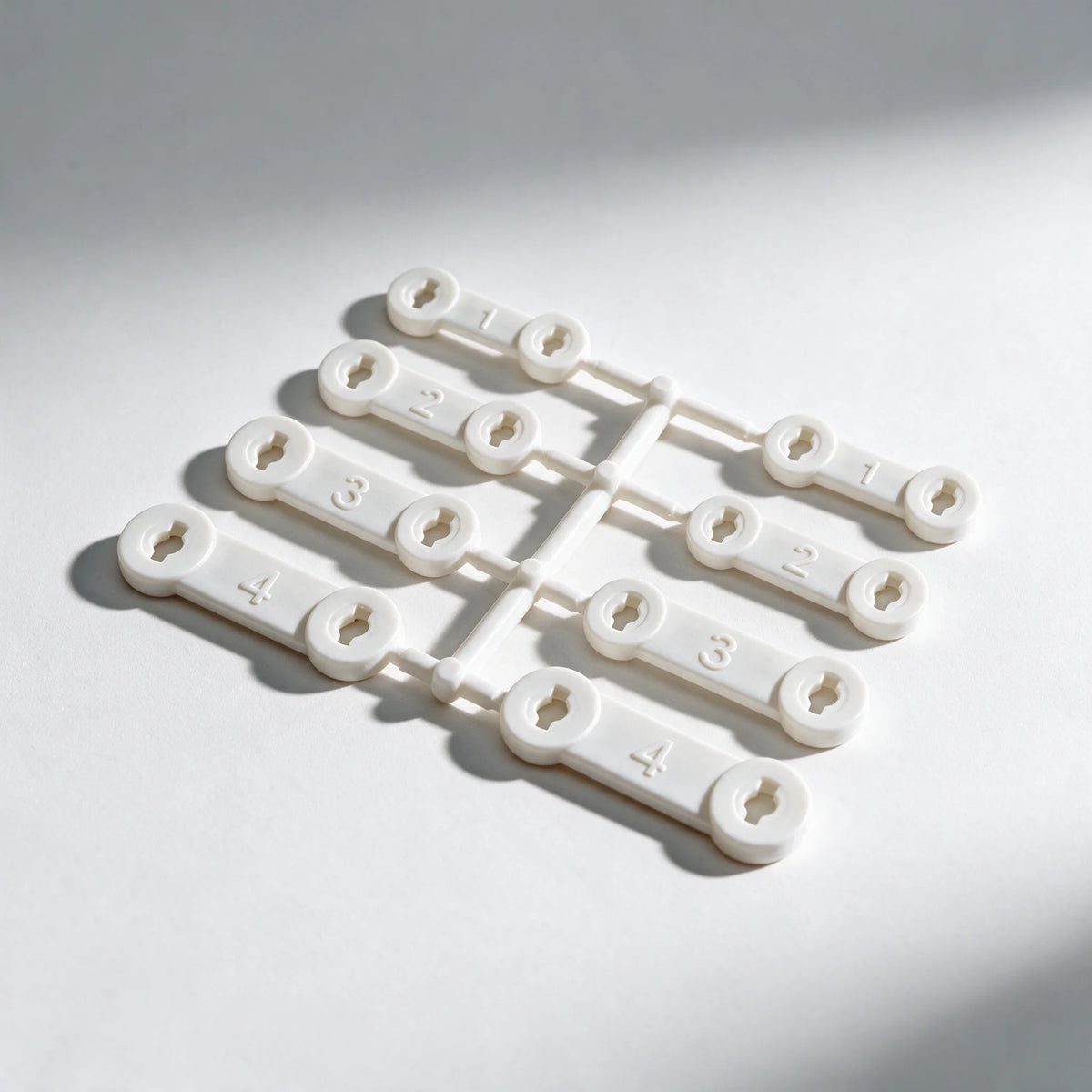 Set of eight numbered Snorbliss replacement straps on their moulding frame